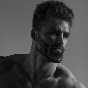 A well-built man in his mid-30s with traditionally masculine and chiseled features looking deep in thought. Popularly referred to as GigaChad.